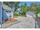 Backyard featuring a paved driveway, detached garage, and a well-maintained lawn at 1413 W Harvard St, Orlando, FL 32804