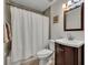 Neat bathroom with tiled shower, wood vanity, framed mirror, and neutral colored walls at 1413 W Harvard St, Orlando, FL 32804