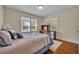 Cozy bedroom featuring wood floors, a comfortable bed, and natural light from two windows at 1413 W Harvard St, Orlando, FL 32804