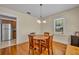 Dining room featuring wooden floors, a table with four chairs, and ample natural light at 1413 W Harvard St, Orlando, FL 32804