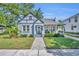 Charming light blue bungalow with a well-manicured lawn and a brick pathway leading to the front door at 1413 W Harvard St, Orlando, FL 32804