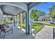 View from the covered front porch with stone floors and an archway, complete with chairs at 1413 W Harvard St, Orlando, FL 32804
