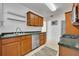 Functional kitchen with wood cabinets, stainless steel dishwasher, and a double basin sink at 1413 W Harvard St, Orlando, FL 32804
