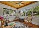 Bright sunroom with wood-paneled ceiling, hardwood floors, and large windows offering scenic outdoor views at 1413 W Harvard St, Orlando, FL 32804