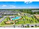 Expansive aerial view of the community featuring a pool, playground, basketball court, and scenic pond at 15186 Book Club Rd, Winter Garden, FL 34787
