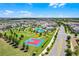 Aerial view featuring a community pool, basketball court, playground, and sidewalks among neighborhood homes at 15186 Book Club Rd, Winter Garden, FL 34787