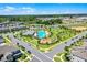 Aerial community view with pool, basketball court, playground, scenic pond, and neighborhood homes at 15186 Book Club Rd, Winter Garden, FL 34787