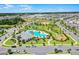 Stunning aerial view of the community featuring a pool, playground, sports court, and lush landscaping at 15186 Book Club Rd, Winter Garden, FL 34787