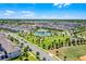 Beautiful aerial view showcasing the community pool, clubhouse, playground, and scenic surroundings at 15186 Book Club Rd, Winter Garden, FL 34787