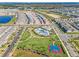 Expansive aerial view of a vibrant community featuring a pool, clubhouse, basketball court, and modern homes at 15186 Book Club Rd, Winter Garden, FL 34787
