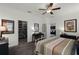 Bright bedroom with ceiling fan, stylish furnishings, and access to an en-suite bathroom at 15186 Book Club Rd, Winter Garden, FL 34787