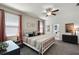 Comfortable bedroom featuring a ceiling fan, windows with curtains, and a spacious closet at 15186 Book Club Rd, Winter Garden, FL 34787