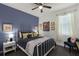 Comfortable bedroom with blue accent wall, decorative pillows, and modern furnishings at 15186 Book Club Rd, Winter Garden, FL 34787