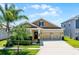 Charming single-Gathering home features a well-manicured lawn and an attached two-car garage at 15186 Book Club Rd, Winter Garden, FL 34787