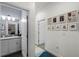 Hallway view to an attached bathroom that features a gray counter, white cabinetry, and a modern faucet at 15186 Book Club Rd, Winter Garden, FL 34787
