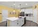 Bright kitchen features an island with quartz countertops and stainless steel appliances at 15186 Book Club Rd, Winter Garden, FL 34787