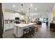 Modern kitchen with a large center island, white cabinets, and stainless steel appliances at 15186 Book Club Rd, Winter Garden, FL 34787
