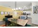 The dining room flows into the kitchen featuring stainless appliances and a center island at 15186 Book Club Rd, Winter Garden, FL 34787