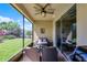 Screened lanai with comfortable seating and a view of the lush backyard, perfect for relaxation at 15186 Book Club Rd, Winter Garden, FL 34787