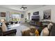 Bright living room with comfortable seating and sliding glass doors leading to an outdoor patio at 15186 Book Club Rd, Winter Garden, FL 34787
