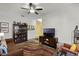Open-concept living room with a large entertainment center, colorful rug, and plenty of seating at 15186 Book Club Rd, Winter Garden, FL 34787