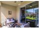 Relaxing covered patio featuring comfortable seating and a sliding glass door that leads to a beautifully landscaped backyard at 15186 Book Club Rd, Winter Garden, FL 34787