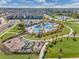 Aerial view showcases the community pool and playground, surrounded by lush green space and sidewalks at 15186 Book Club Rd, Winter Garden, FL 34787