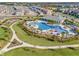 Beautiful community pool area with palm trees, lounge chairs, splash pad, and a nearby playground at 15186 Book Club Rd, Winter Garden, FL 34787