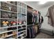 Organized walk-in closet with shelves, clothing racks, shoe storage and displays of clothing and accessories at 15186 Book Club Rd, Winter Garden, FL 34787