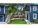 Backyard features a green artificial turf lawn, patio seating, and access to upper level at 1521 E Harwood St, Orlando, FL 32803