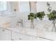Bright bathroom vanity featuring white marble countertops, modern faucet, and decorative floral accents at 1521 E Harwood St, Orlando, FL 32803