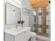 Well-lit bathroom featuring marble countertops, a glass shower, and a wood-paneled ceiling at 1521 E Harwood St, Orlando, FL 32803