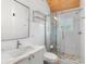 Bright bathroom featuring a glass shower and marble countertop with sink and toilet at 1521 E Harwood St, Orlando, FL 32803
