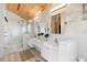 A luxurious bathroom featuring white cabinets, a glass shower, and a wood ceiling at 1521 E Harwood St, Orlando, FL 32803