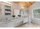 Bright bathroom featuring white cabinetry, double sinks and a light-filled shower at 1521 E Harwood St, Orlando, FL 32803