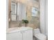 Bathroom with modern vanity, marble countertop, framed mirror and stylish lighting at 1521 E Harwood St, Orlando, FL 32803