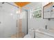 Modern bathroom featuring glass shower, marble accents, and bright natural light at 1521 E Harwood St, Orlando, FL 32803