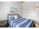 Bright bedroom with blue and white bedding and an abstract art piece over the bed at 1521 E Harwood St, Orlando, FL 32803