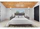 Comfortable bedroom featuring hardwood floors, a wood ceiling and a gray headboard at 1521 E Harwood St, Orlando, FL 32803
