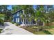 Beautiful blue two-story home with a charming front porch, lush landscaping, and a welcoming ambiance at 1521 E Harwood St, Orlando, FL 32803