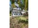 Charming two-story home with a blue exterior, a welcoming front porch, and a well-manicured lawn at 1521 E Harwood St, Orlando, FL 32803