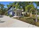 Two-story home features a blue exterior, white trim, front porch with rocking chairs, and green lawn at 1521 E Harwood St, Orlando, FL 32803