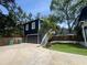 Charming two-story home with dark blue siding, modern garage, and an inviting front yard at 1521 E Harwood St, Orlando, FL 32803
