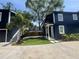 Two story home with dark blue siding, modern architectural style, and a well manicured yard at 1521 E Harwood St, Orlando, FL 32803