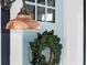 Inviting light-blue front door with decorative wreath and stylish copper-toned exterior light fixture at 1521 E Harwood St, Orlando, FL 32803