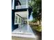 Side view of a covered front porch, showcasing white rocking chairs and decorative tile accents at 1521 E Harwood St, Orlando, FL 32803
