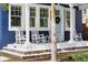Charming front porch with multiple rocking chairs and vibrant decorative tile accents on the steps at 1521 E Harwood St, Orlando, FL 32803