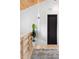 Hallway features wood floors, white walls, black door, wood banister, and modern lighting at 1521 E Harwood St, Orlando, FL 32803