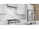 Modern kitchen showcasing white cabinets, stainless steel appliances, and white marble countertops at 1521 E Harwood St, Orlando, FL 32803