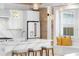 Stylish kitchen showcasing white cabinetry, marble countertops, pendant lighting, and stainless steel appliances at 1521 E Harwood St, Orlando, FL 32803